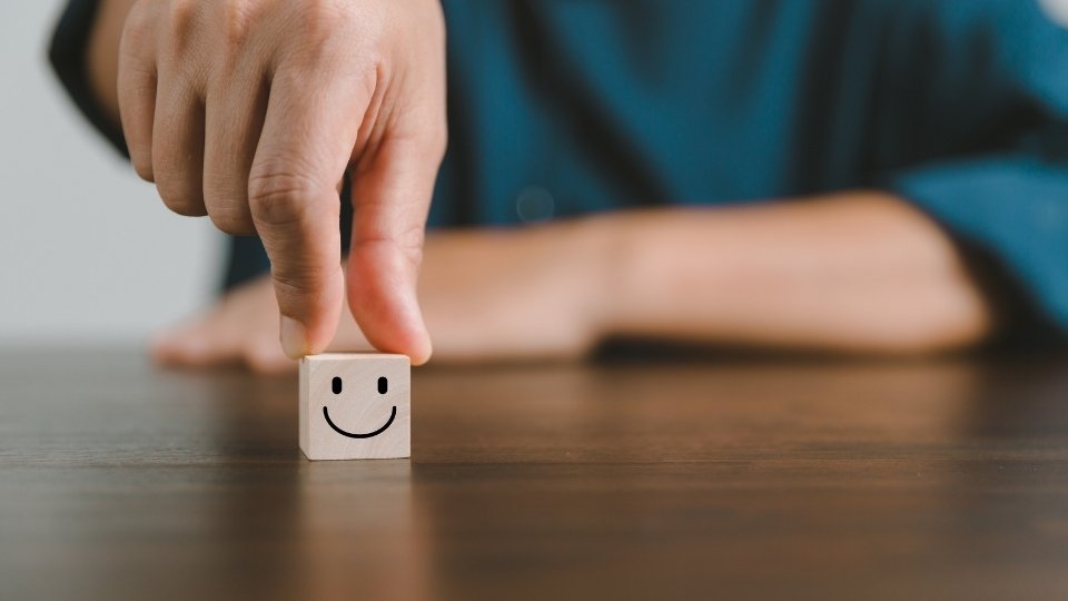Do Sober Living Homes Need to Be Licensed? 1 Do Sober Living Homes Need to Be Licensed a man holds a dice indicating the happiness found in sober living.